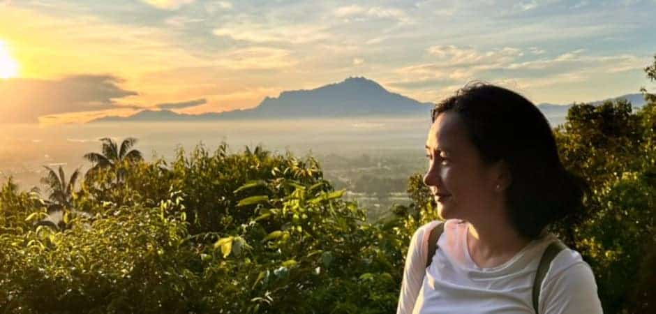 Author admiring sunrise over Mount Kinabalu